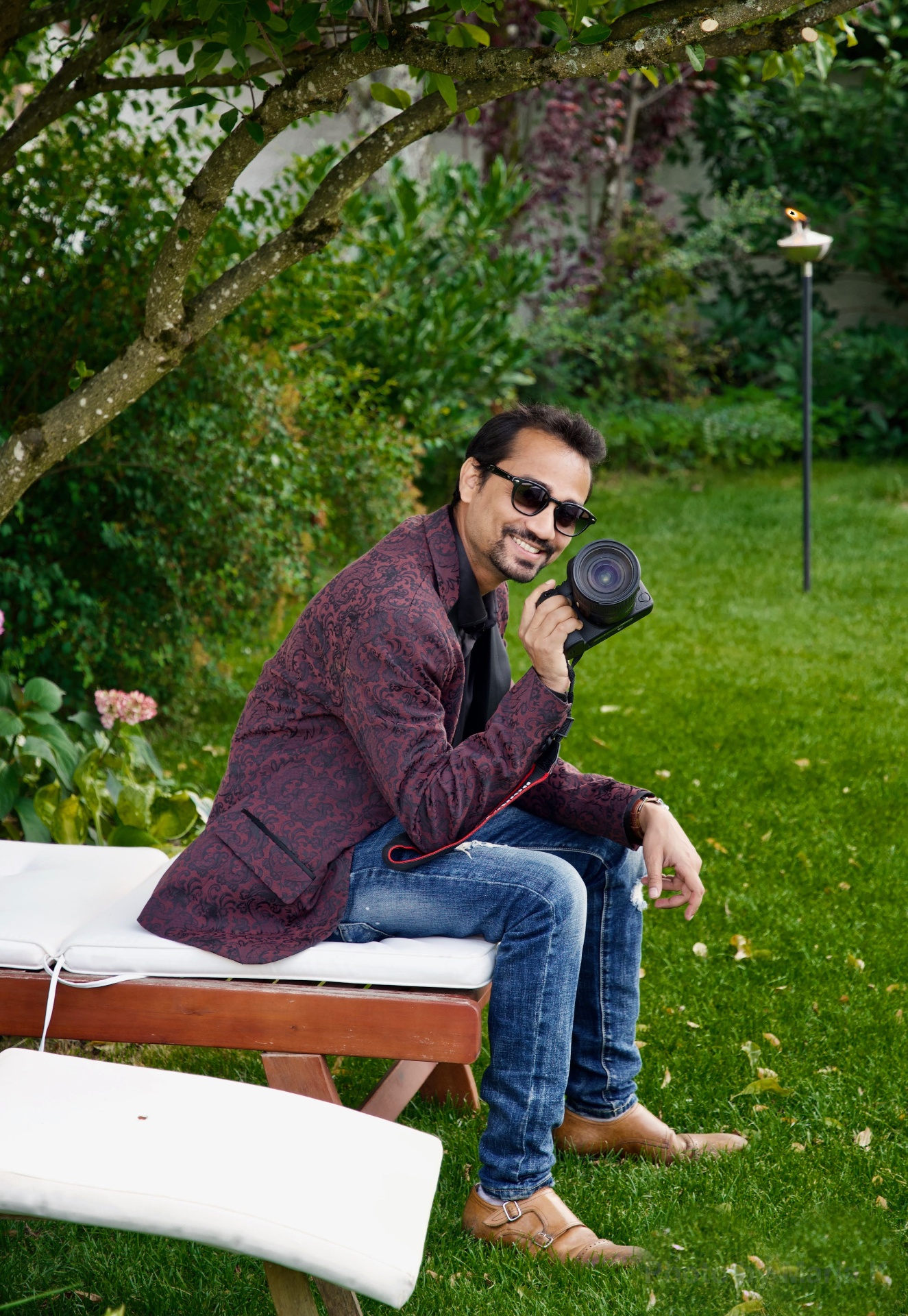Indro, founder of ZFG Experience, holding his camera outdoors